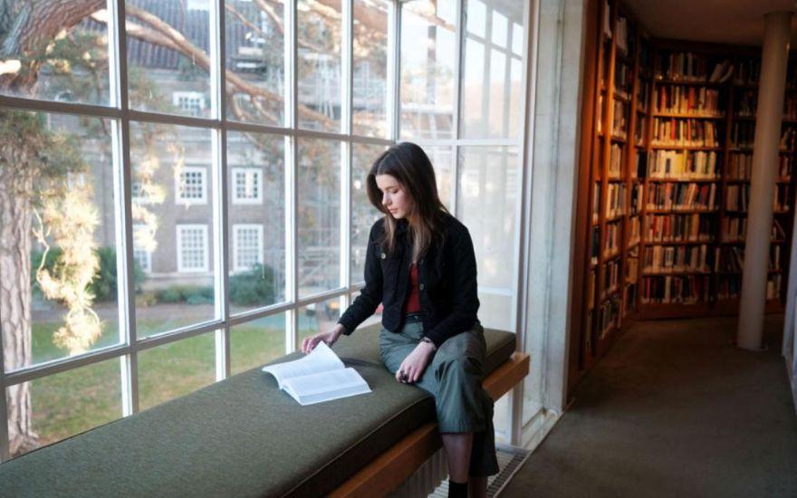 Student sitting in Library window